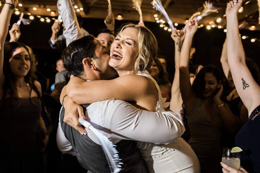 Couple lifted up on a packed reception dance floor